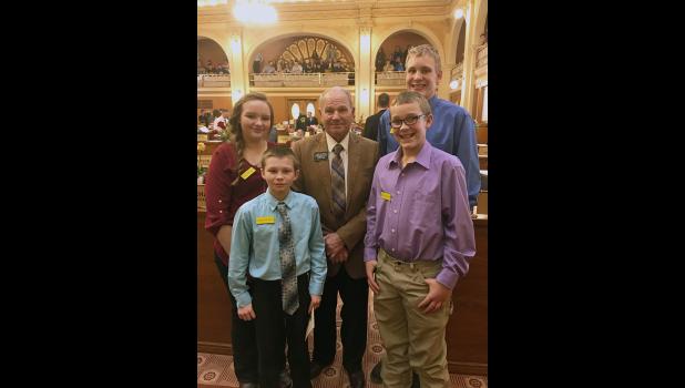 Front row (L-R): Matthew Birkeland and Dylan Fuoss. Back row (L-R): Brianna Smith, Representative James Schaefer and Ty Fuoss.