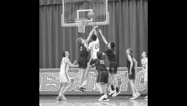 Asa Best is surrounded by Lyman defense as he goes up for a shot. Photo by Mishayla Buchannan