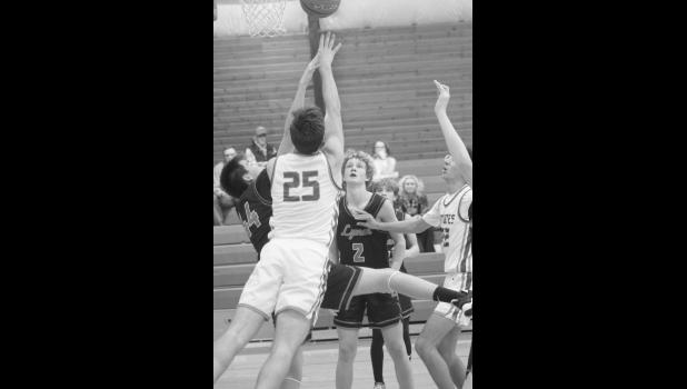 Cooper Feddersen goes up for a block. Photo by Mishayla Buchannan
