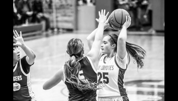 Jacey Jensen keeps the ball out of reach. Photo Barb Hockenbary Photography