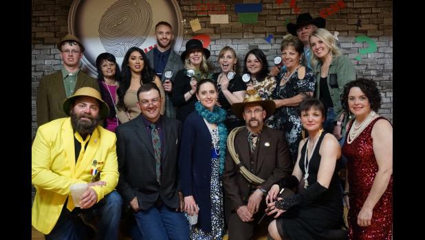 Winners ... The dining room crew won the Clue... Live event by solving the mystery. They are pictured here with the cast of colorful characters. Courtesy Photo