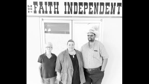 Business as usual ... during the ownership transition of The Faith Independent. New owners Russel and Krissy Johnson pictured with Faith team member Loretta Passolt. Courtesy Photo