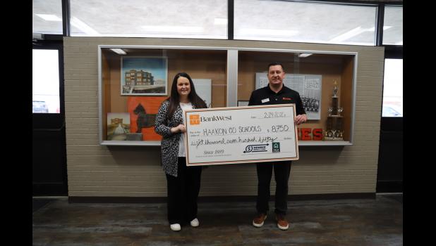 BankWest Insurance Agent Joel Spry presents a check to Skye Holsether. Courtesy Photo