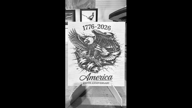 A wooden plaque engraved for America’s 250th anniversary, made and donated by Dennis Uthe.