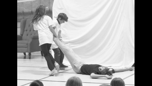 Busy bees drag away the Big Bad Wolf, who passed out trying to blow down the brick house. Sutton Lolley, Abel Bowman, and Jameson Tucker.