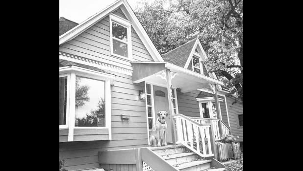 In late September, Nathaniel and Jeanette Putney purchased this home in Madison, South Dakota for roughly $145,000 in cash. The couple’s dog, Poet, sits on the front porch. Photo Courtesy of Nathanial Putney