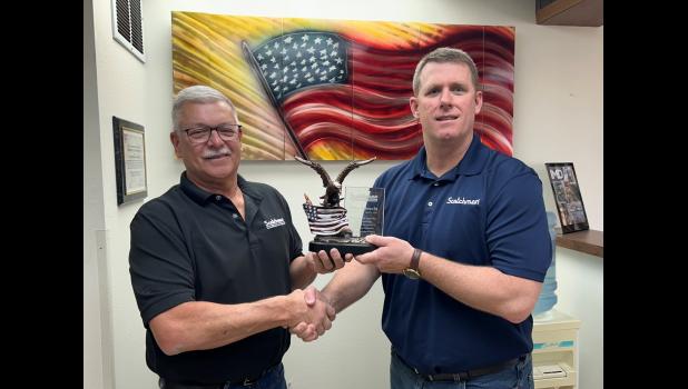 Scotchman General Manager, Brad Heltzel, presents Mike Albrecht with a token of appreciation for his years of service.
