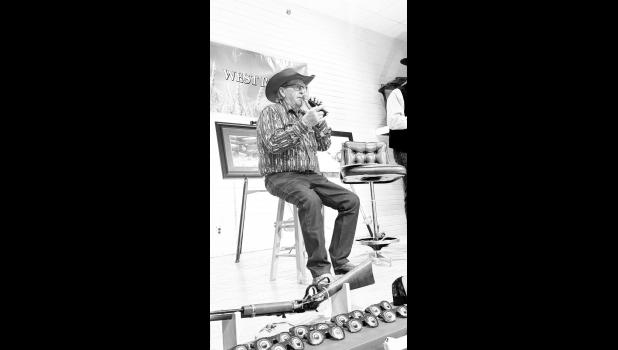 Bill Eckert auctioneers for the evening.