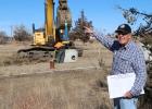M.R. Hansen points to the cedar trees that surrounded the house that he grew up in. The house was taken out to make room for new lots for approximately 17 houses.