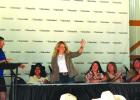 Britni Ross waves from the stage upon being named Dakotafest Woman Farmer of the Year Thursday. She helps run two ranches near Philip, S.D., using her background in financial management. Tri-State Neighbor photo by Janelle Atyeo